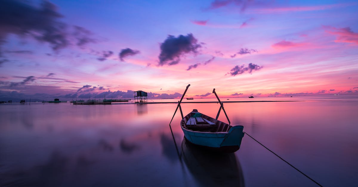 blue-and-white-boat-on-body-of-water-1