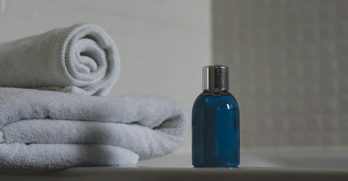 blue-glass-bottle-beside-white-towel