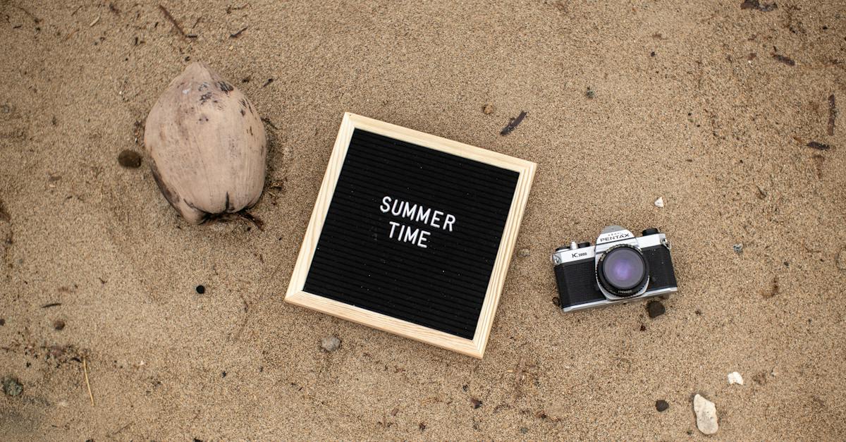 board-with-text-summer-time-and-analog-camera-on-the-beach