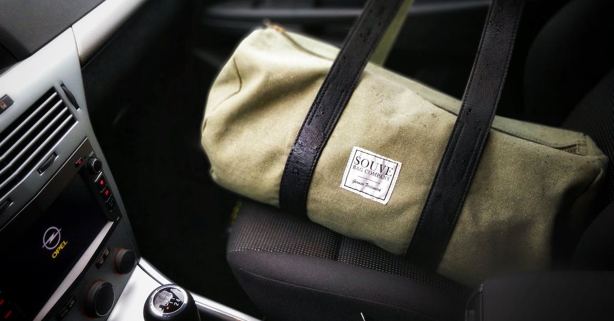 brown-and-black-duffel-bag-on-a-car-seat