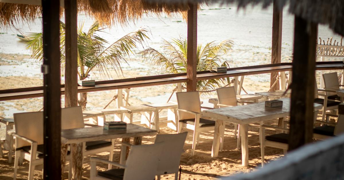 brown-wooden-table-and-chairs-on-beach