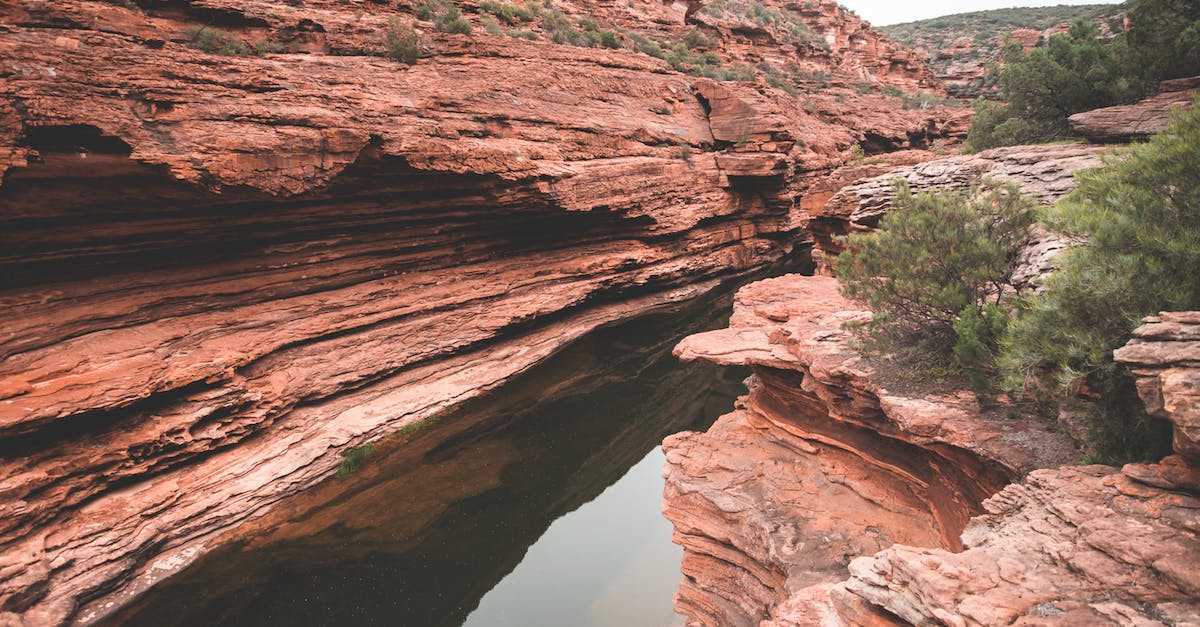 calm-narrow-river-between-rocky-canyon