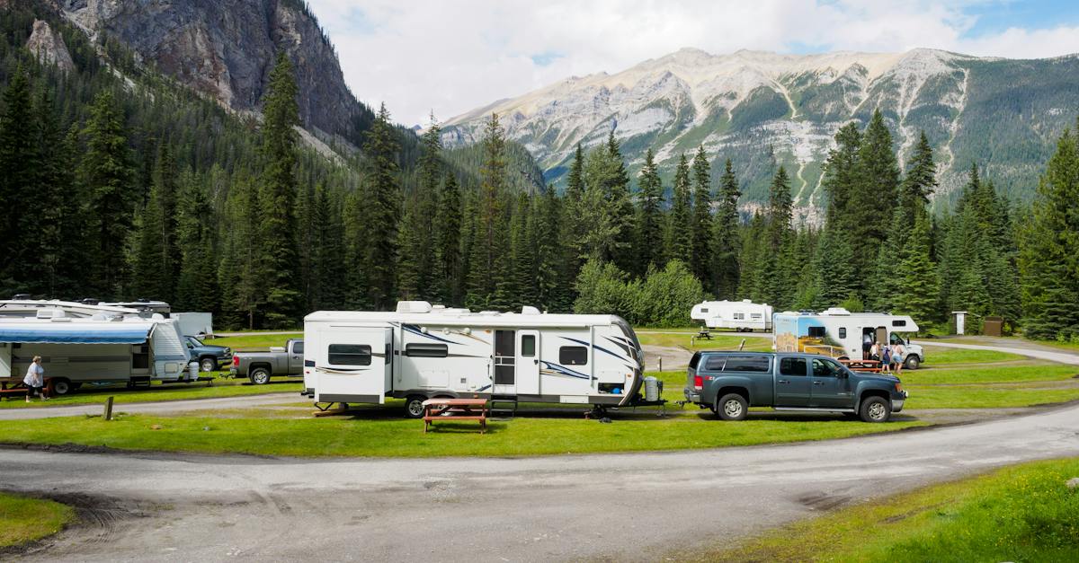 cars-with-trailers-at-a-campsite-in-mountains