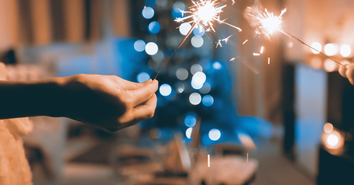 close-up-photograph-of-two-person-holding-sparklers
