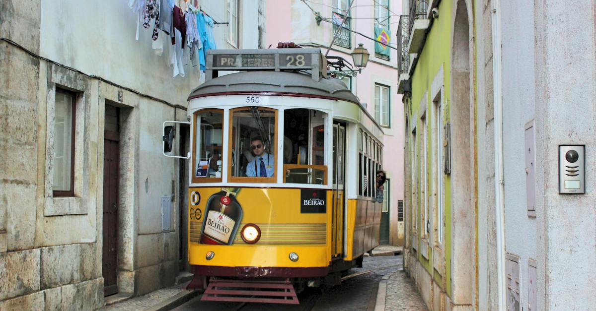 famous-old-fashioned-number-28-lisbon-tram-in-narrow-street-of-lisbon-with-shabby-buildings