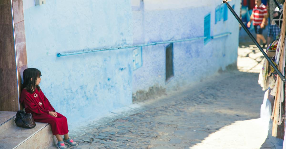 girl-sitting-on-street-stairs-in-indigenous-outdoor-market