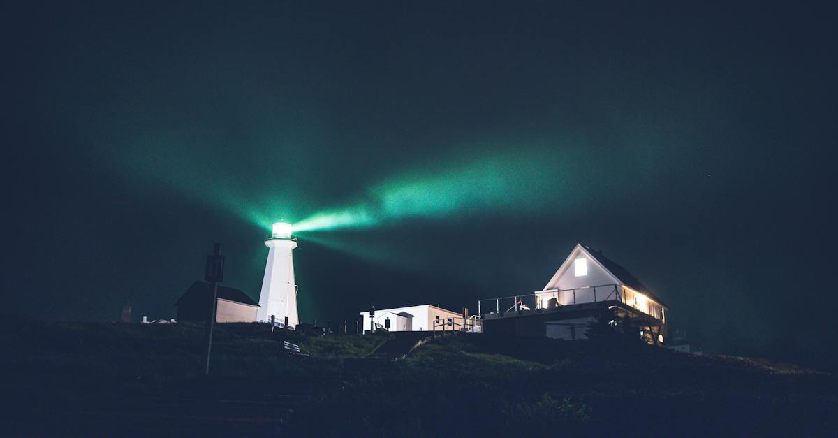 green-lighthouse-in-dark-night-on-hill