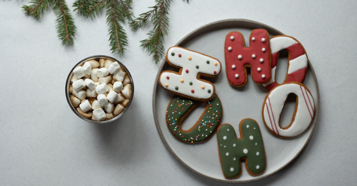 overhead-view-of-tasty-biscuits-in-form-of-letters-with-decor-near-hot-drink-with-marshmallows-and-f