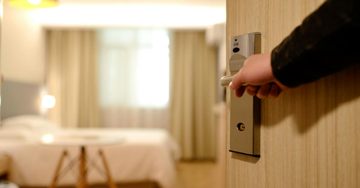 person-holding-on-door-lever-inside-room-2