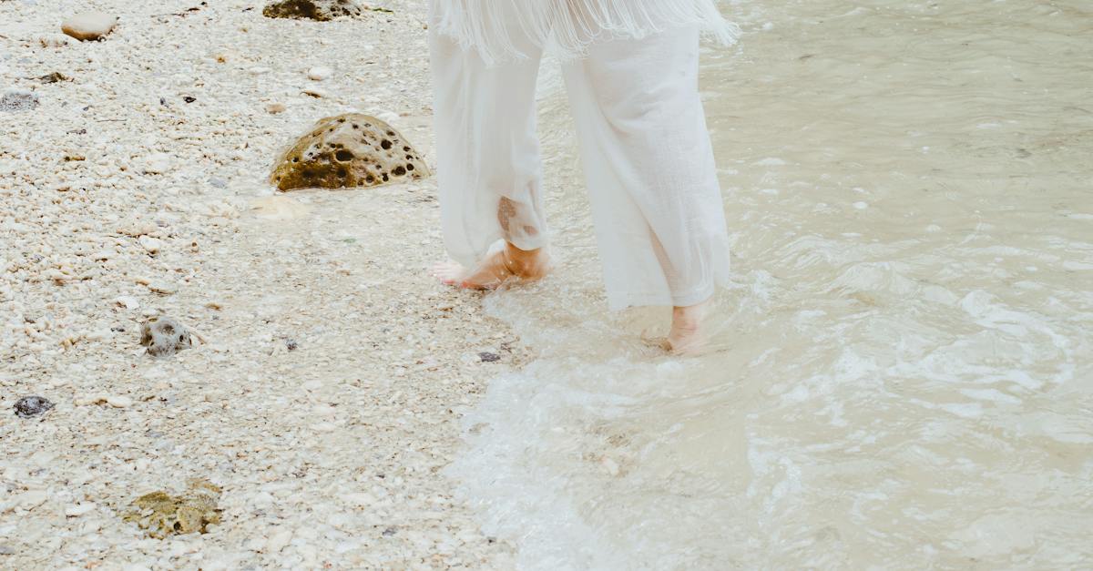 person-in-white-pants-in-beach