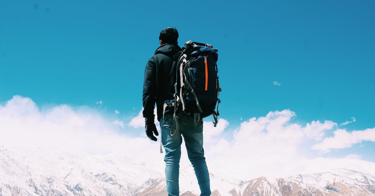 photo-of-man-standing-on-top-of-mountain-1