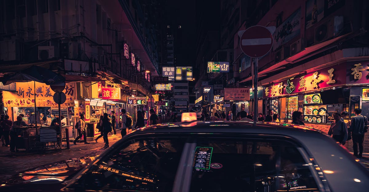 photo-of-taxi-near-buildings-during-nighttime