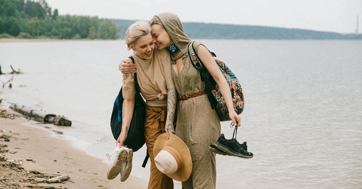 photo-of-women-embracing-while-standing-on-beach