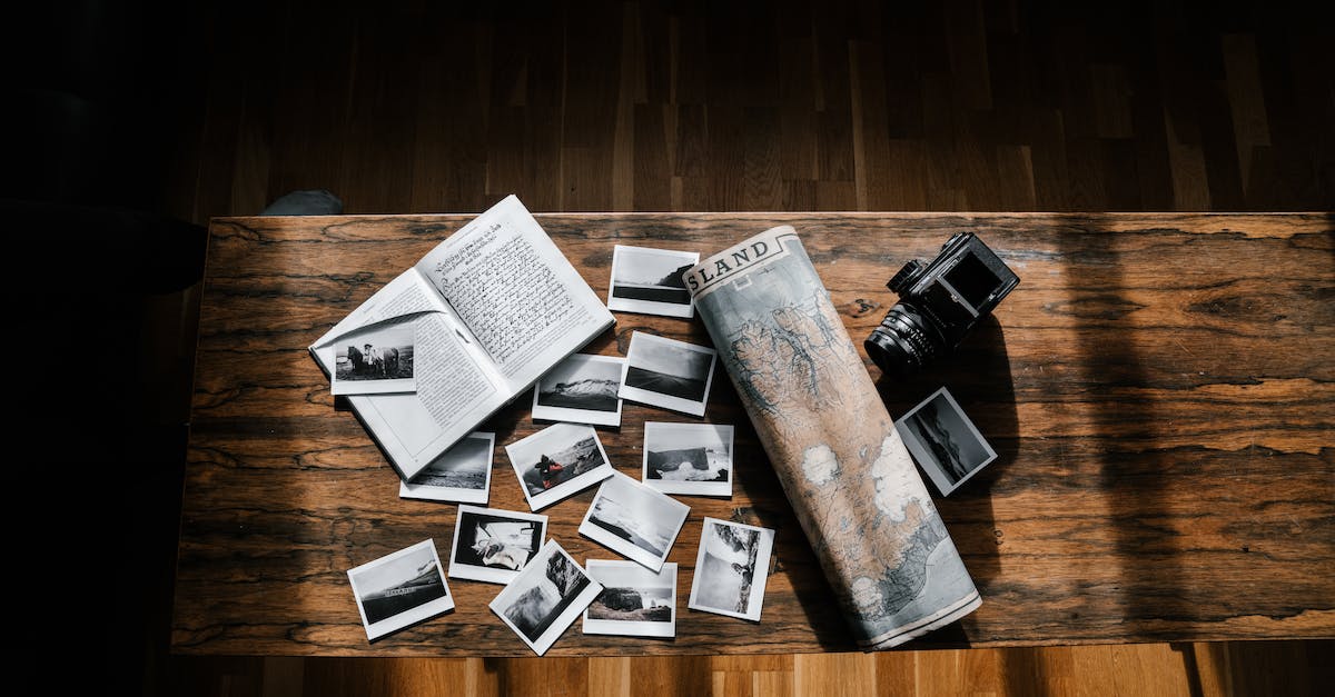 photos-and-journal-with-map-and-camera-on-wooden-table