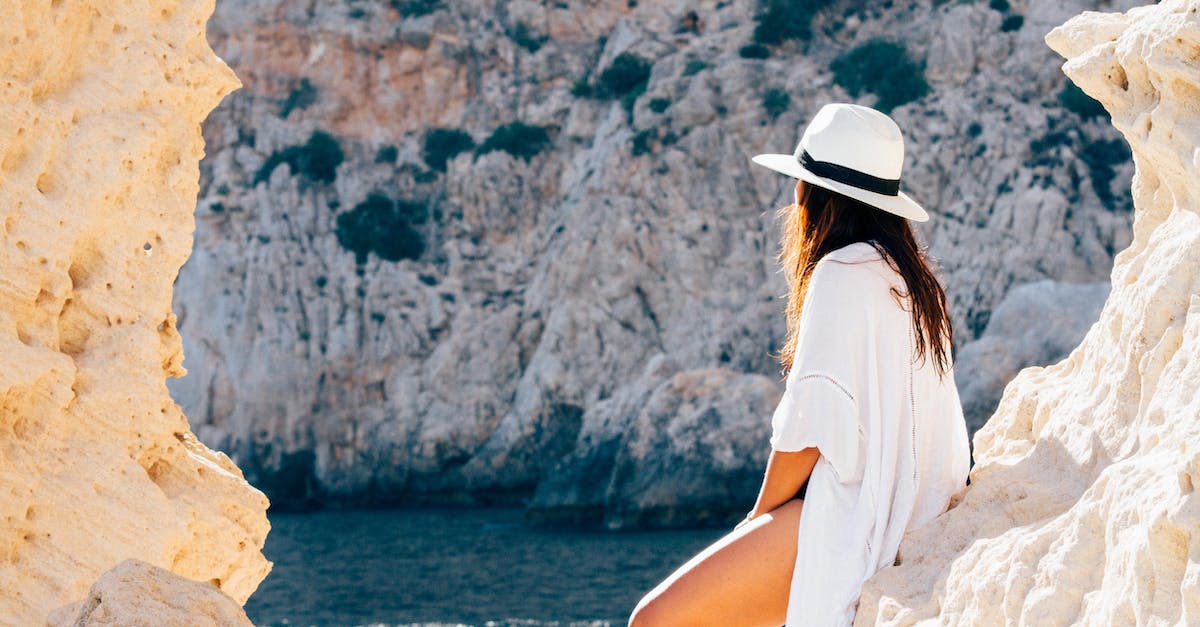 rear-view-of-woman-sitting-on-a-rock