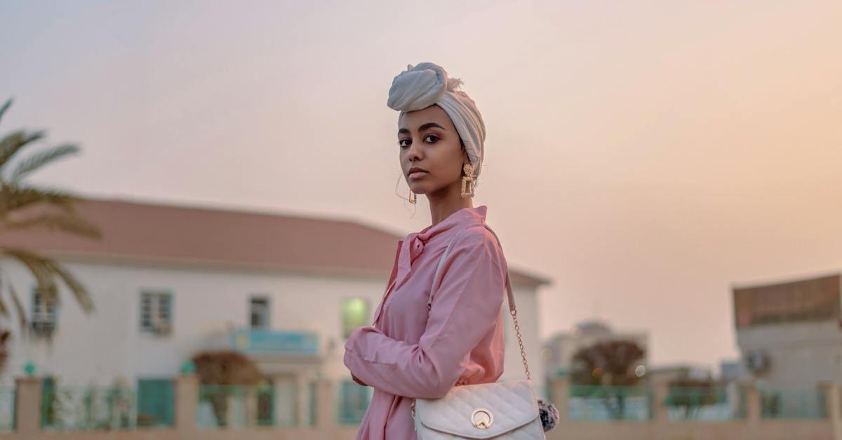 selective-focus-photograph-of-woman-in-pink-dress-with-leather-bag