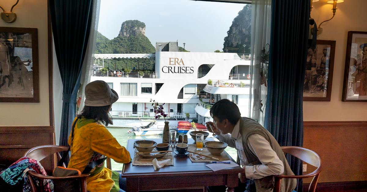 side-view-of-ethnic-male-tourist-eating-soup-against-unrecognizable-female-beloved-at-table-on-motor-1