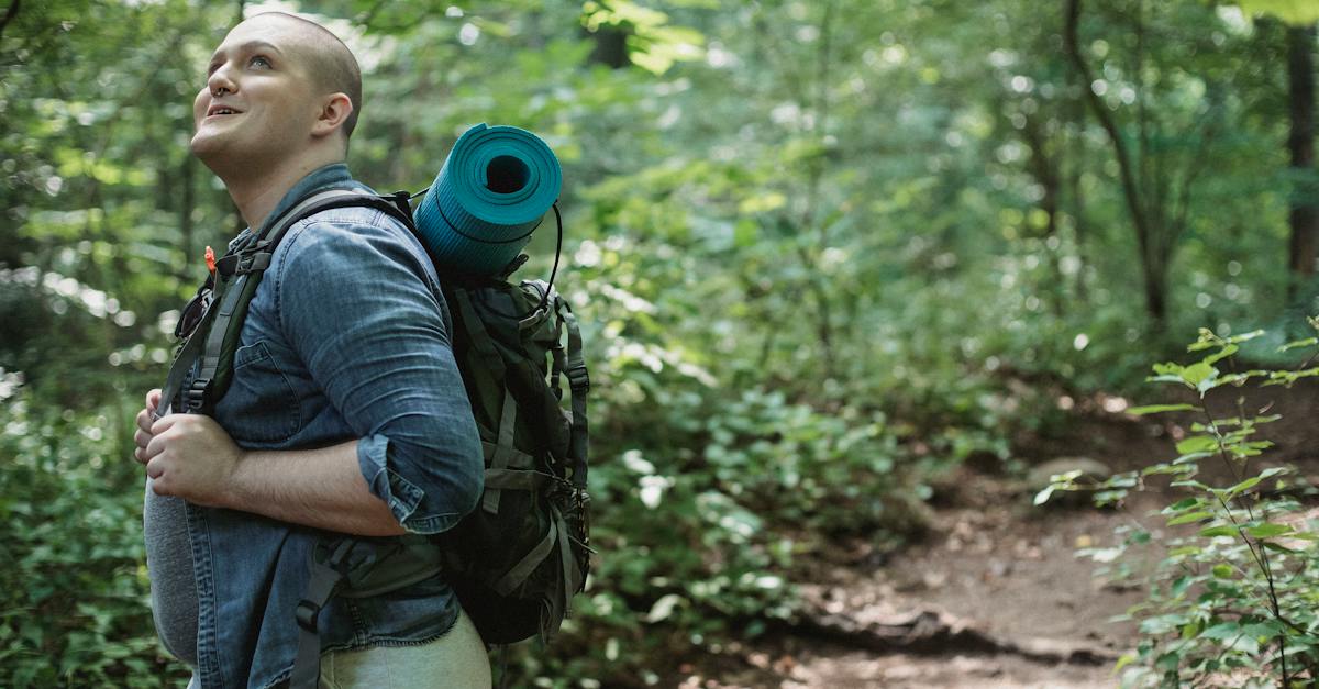 side-view-of-overweight-smiling-man-travelling-through-green-lush-woods-and-enjoying-vacation-in-nat