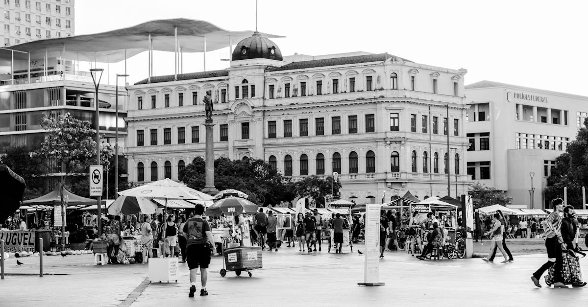 square-in-centre-of-big-city-with-big-buildings-and-open-market-stalls-and-full-of-people-in-sunny-s-1