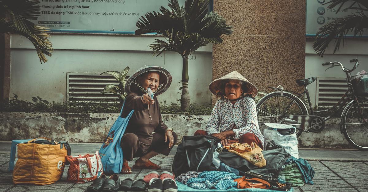 two-women-sitting-on-the-sidewalk