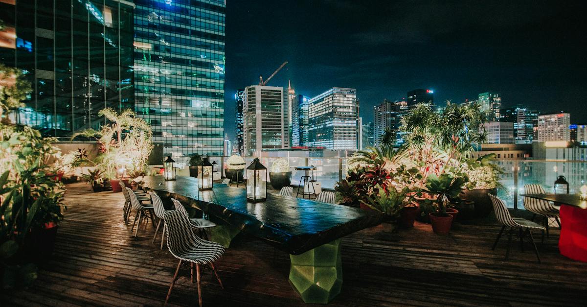 view-of-the-cityscape-from-a-rooftop-garden-restaurant-at-night