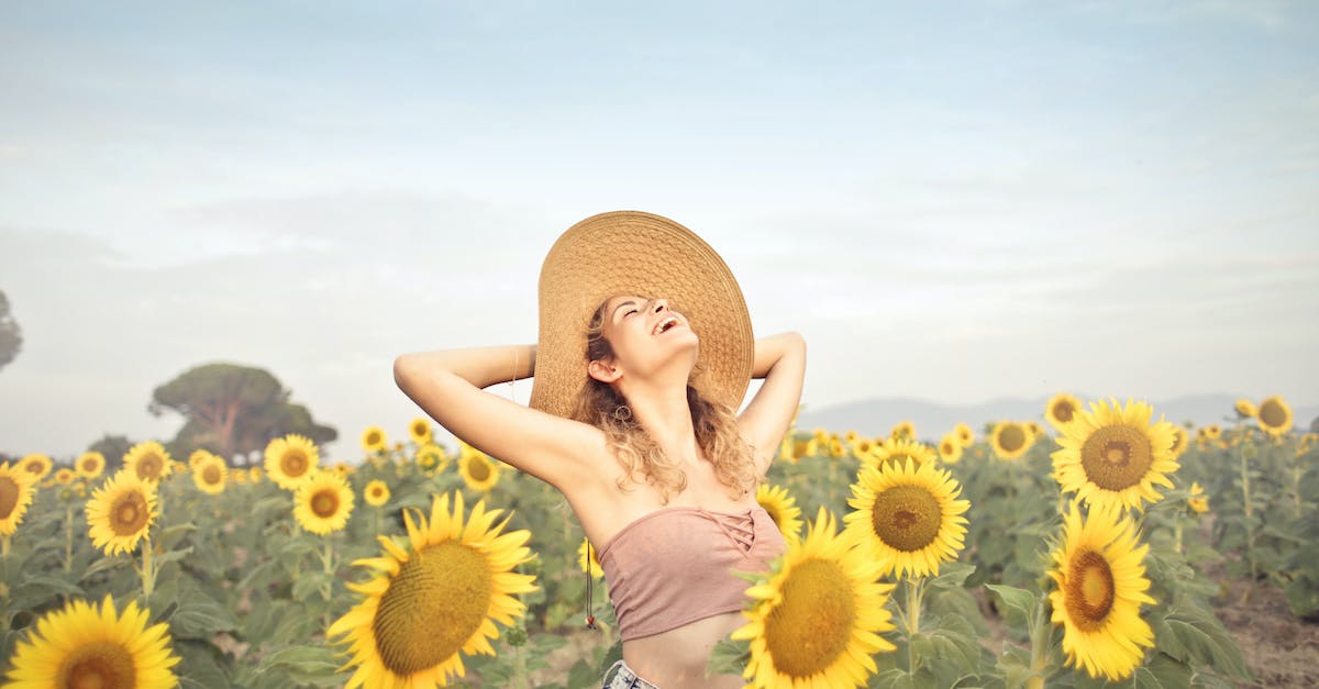 woman-standing-on-sunflower-field