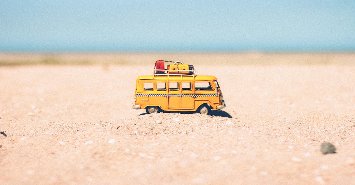 yellow-die-cast-miniature-van-on-brown-sand