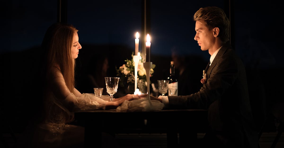 young-elegant-couple-holding-hands-during-romantic-dinner-in-restaurant